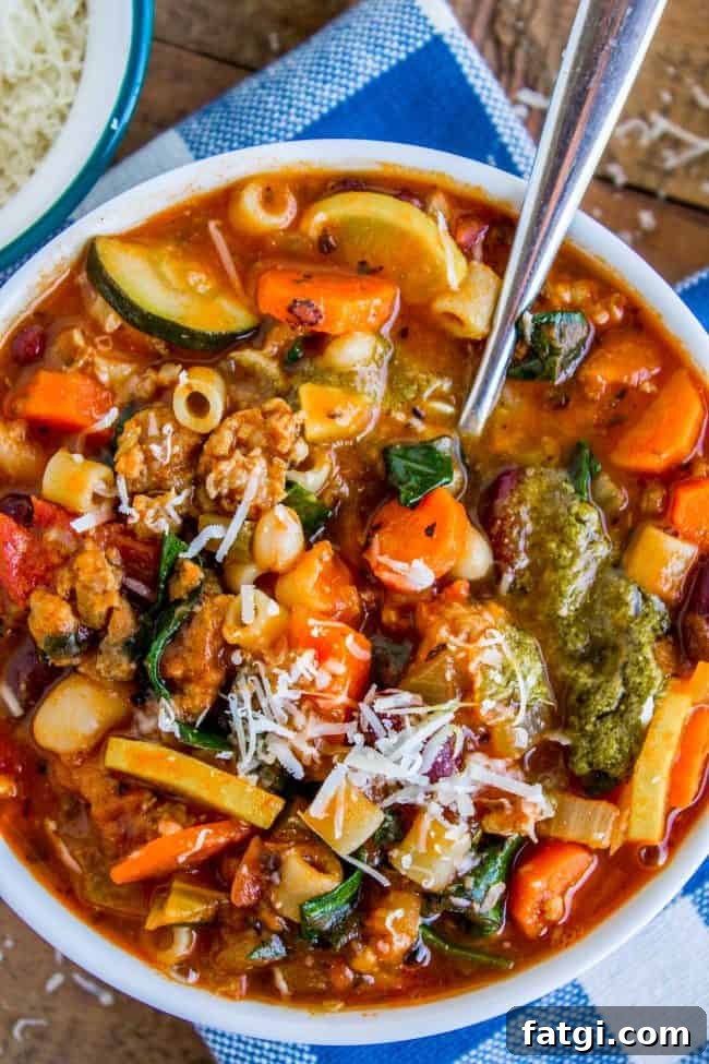 minestrone soup in a bowl with a spoon.