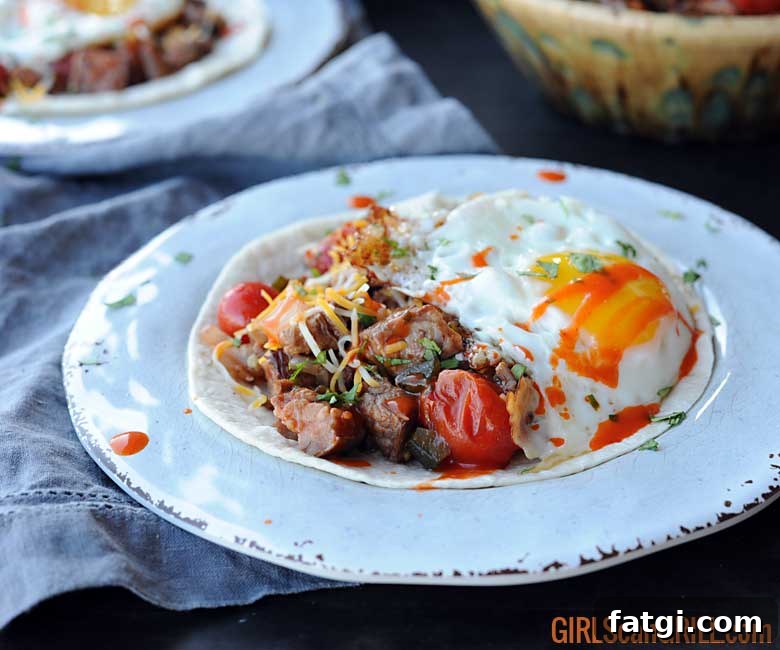 white plate with tortilla, beef, salsa and egg