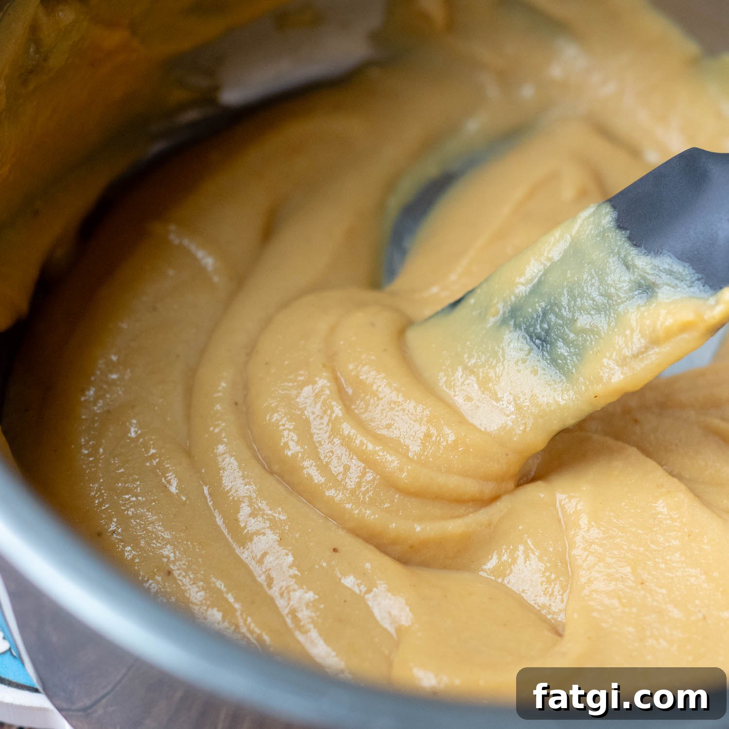 a spoon showing the thickness of the mustard sauce.