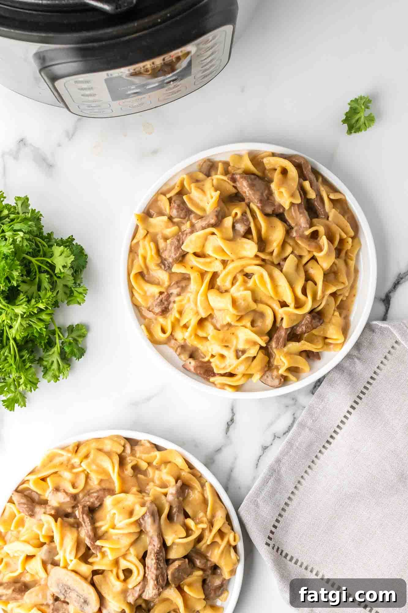 Instant Pot Beef Stroganoff with Tender Beef and Creamy Sauce 4 Instant Pot Beef Stroganoff served in two white plates
