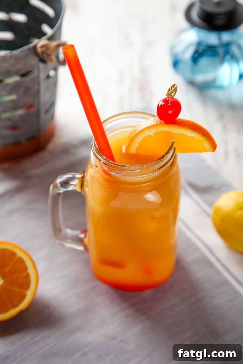 a planters punch drink with an orange slice and cherry garnish.