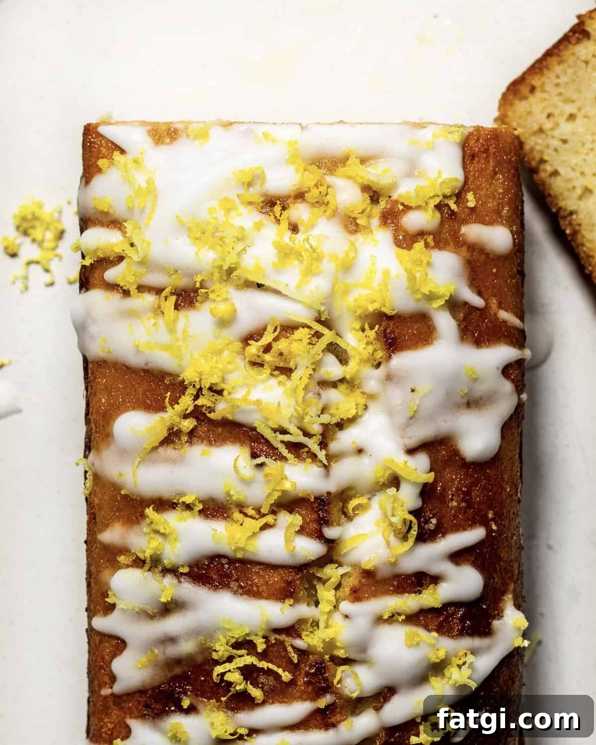Gluten-Free Lemon Drizzle Loaf Cake Recipe 7 A lemon drizzle loaf cake with lemon icing and lemon zest photographed from above.