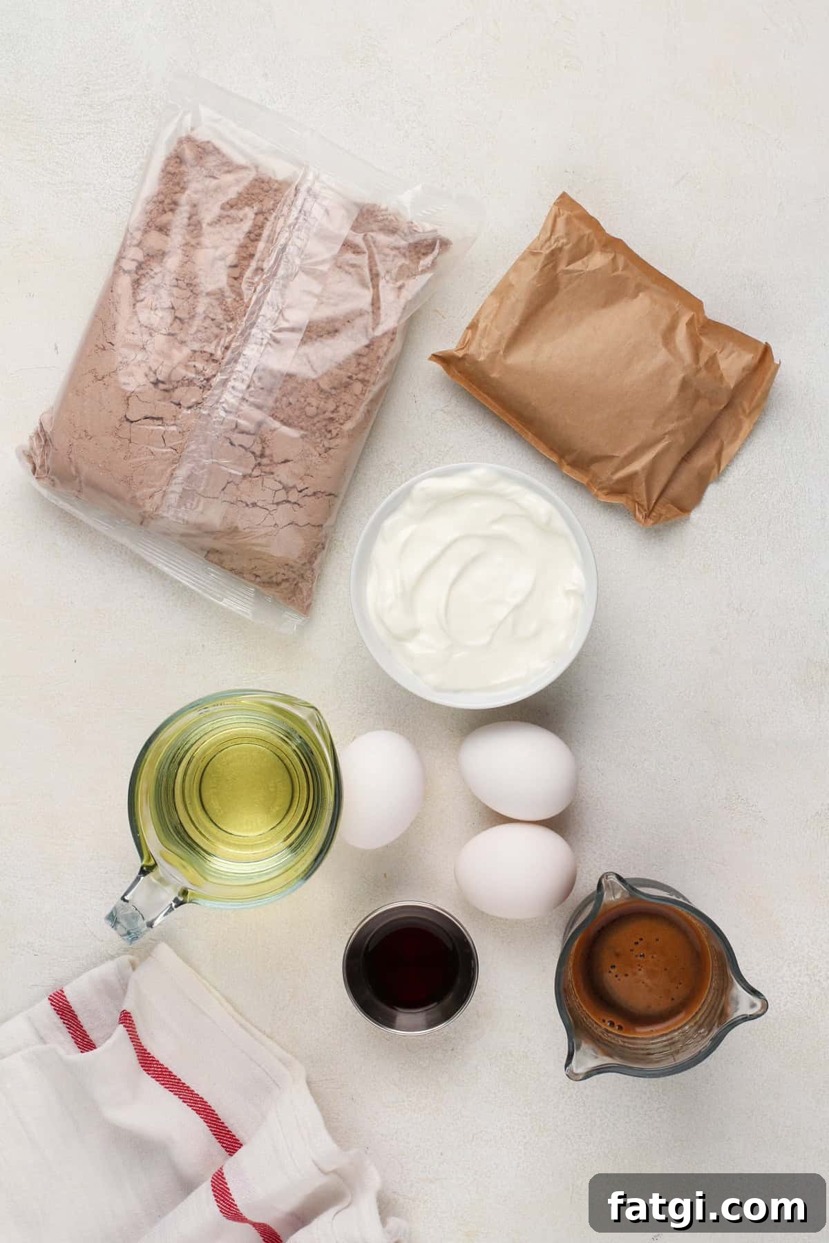How to Transform Boxed Cake Mix into Gourmet Cakes 5 Ingredients for doctored cake mix arranged on a countertop.