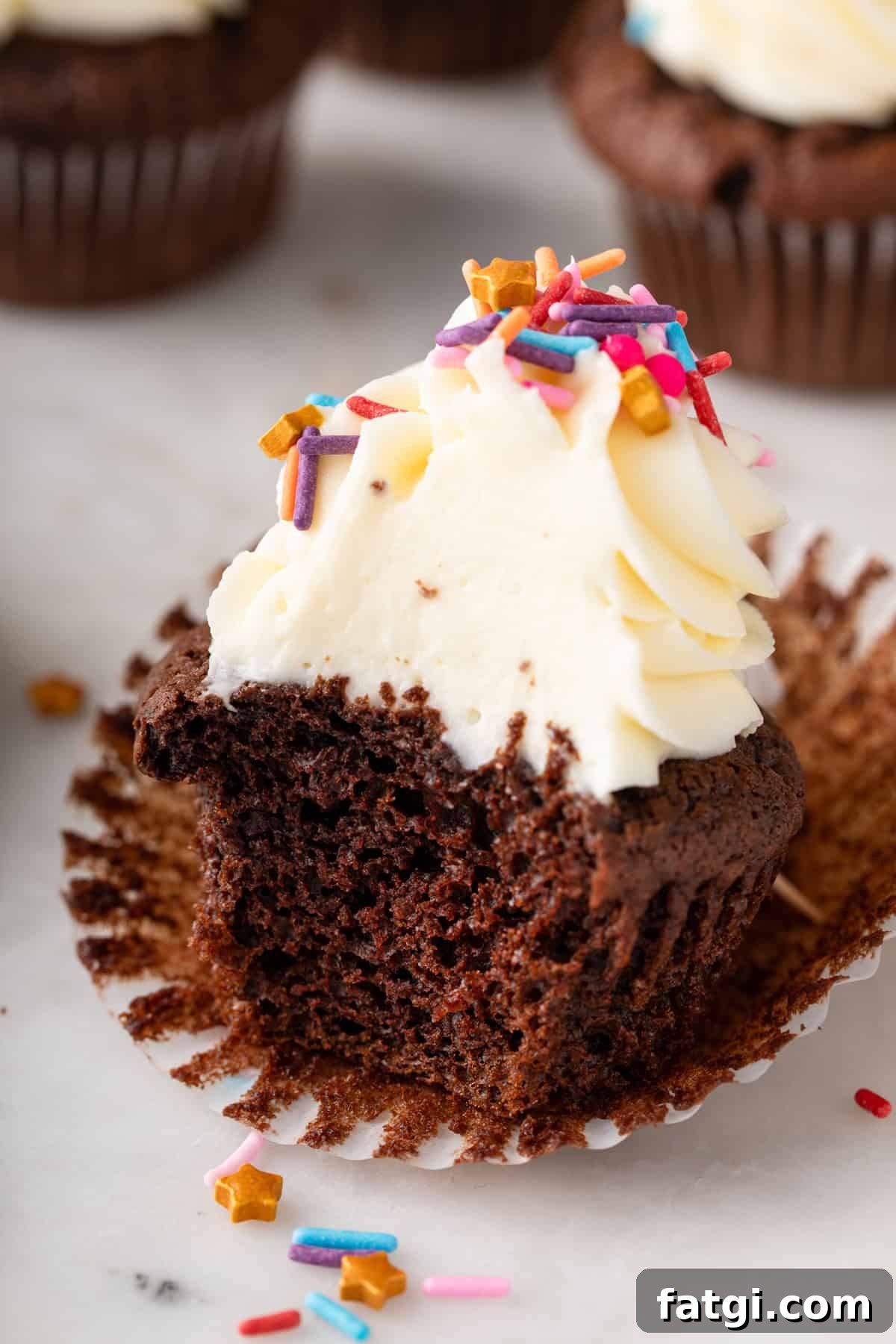 How to Transform Boxed Cake Mix into Gourmet Cakes 8 Bite taken from a chocolate cupcake made with doctored cake mix.