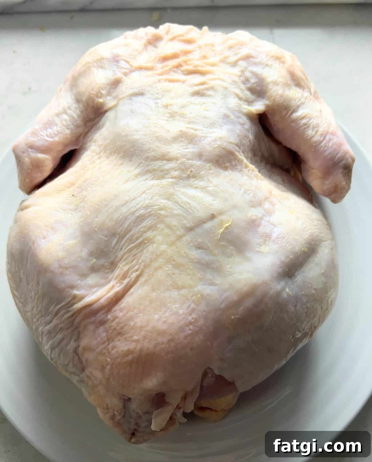 One patted dry whole chicken ready for air fryer.