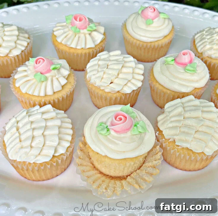 Platter of vanilla cupcakes, frosted with buttercream ruffles and roses