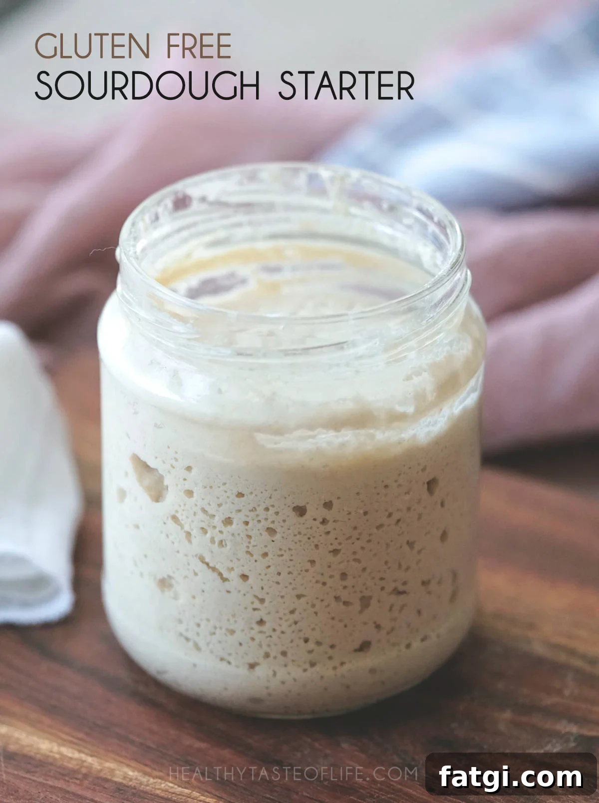 Active gluten-free sourdough starter, bubbly and risen in a jar ready to be used in this gluten free sourdough bread recipe.