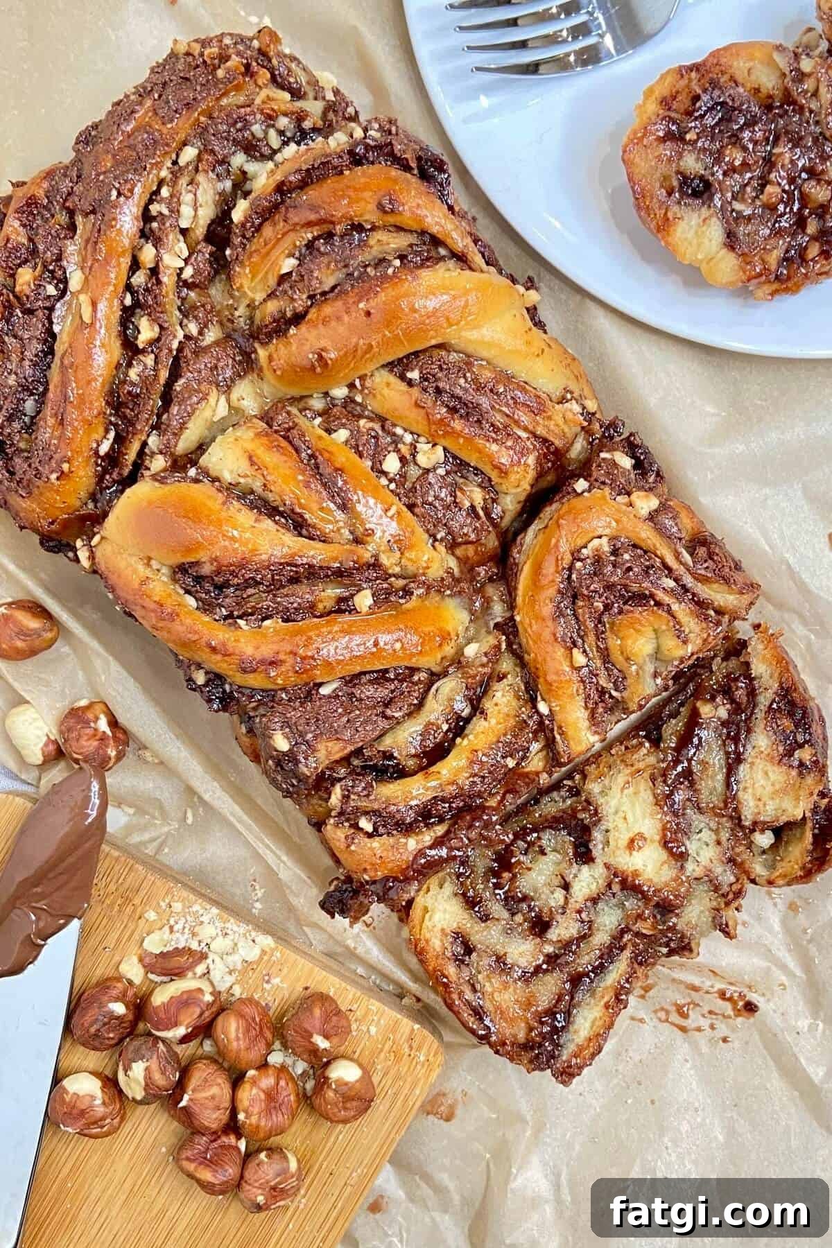 Sliced babka, with hazelnuts on chopping board.
