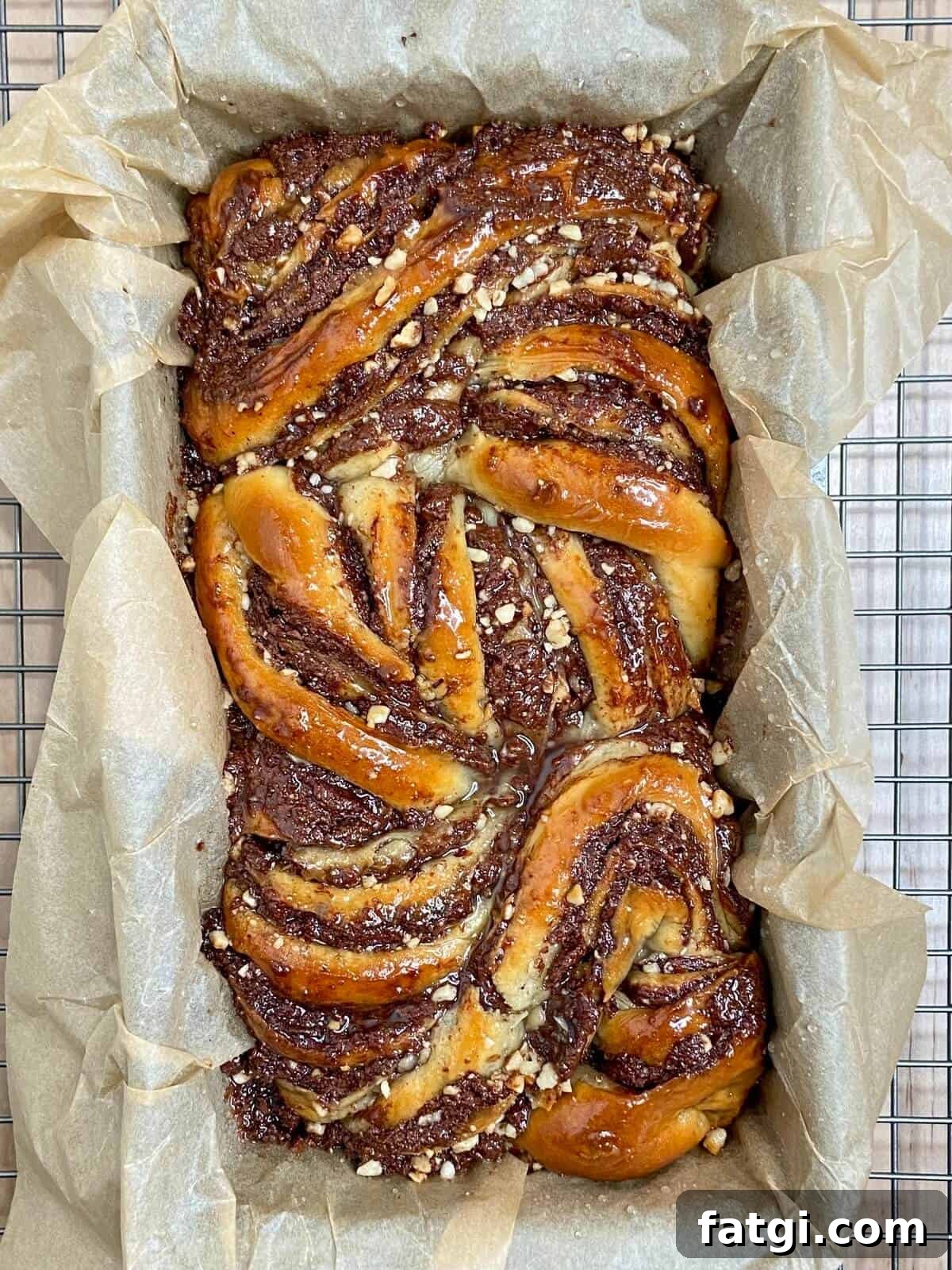 Finished babka on parchment paper in loaf pan.