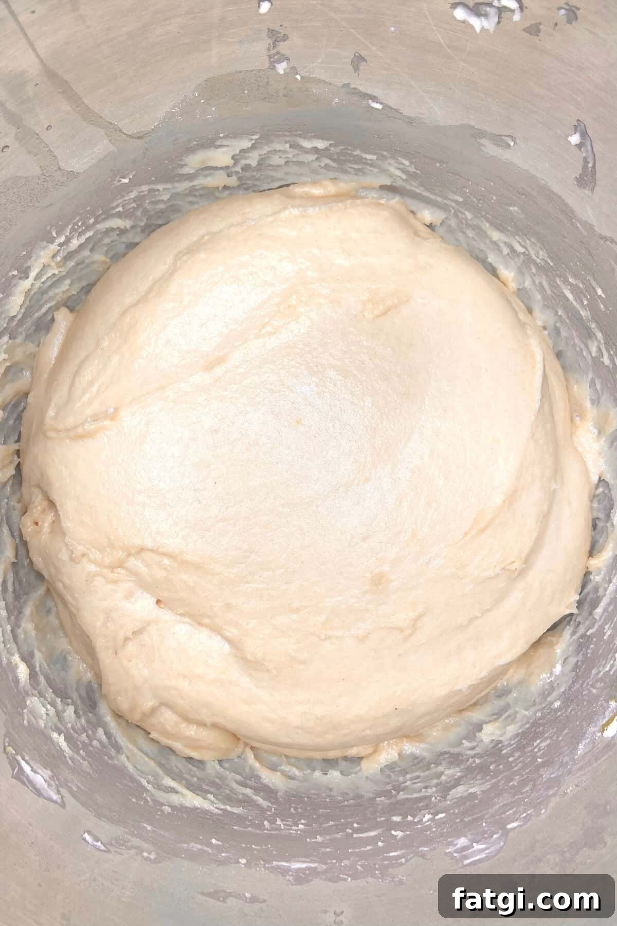 Dough in stainless steel bowl.