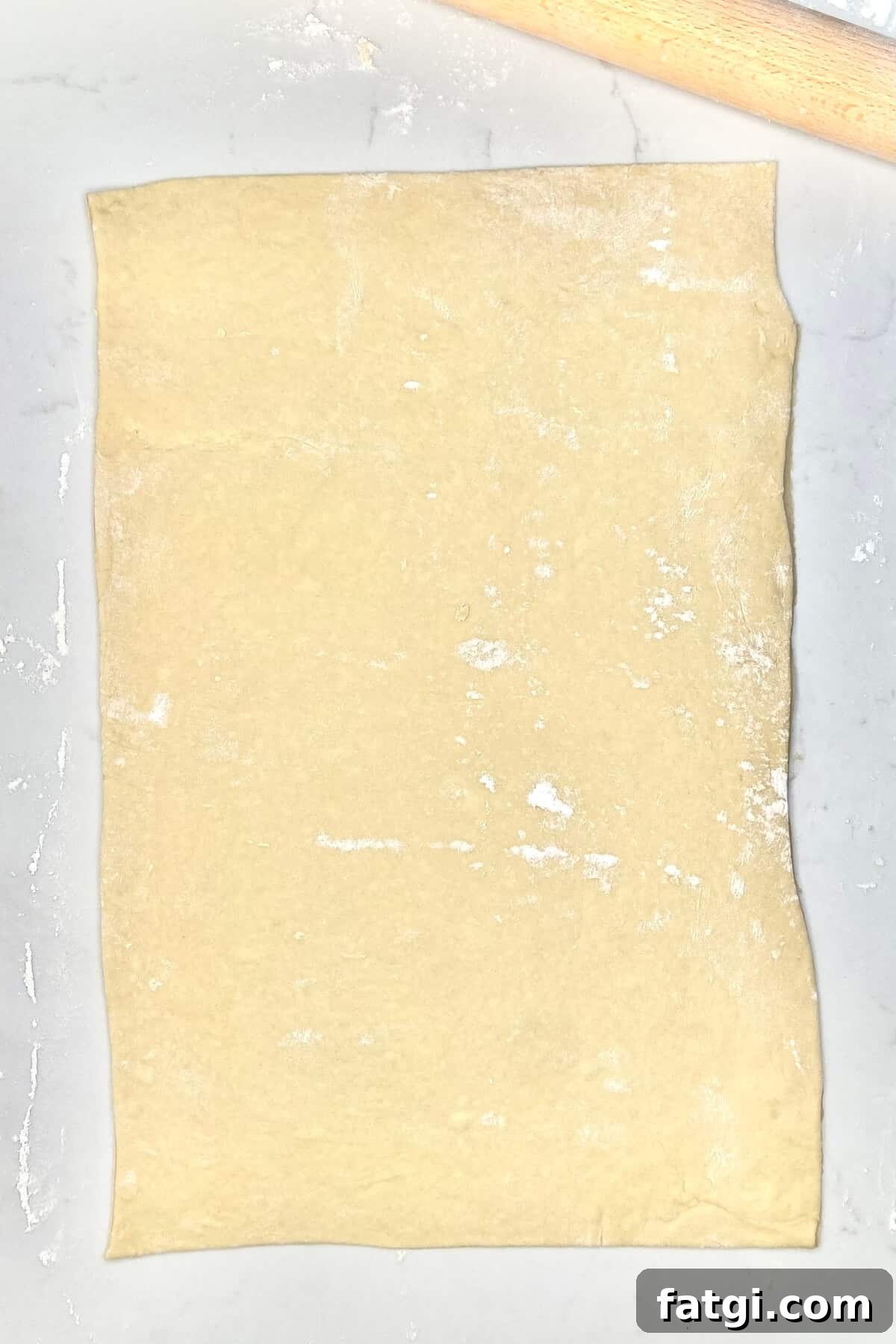Rolled out dough on countertop.