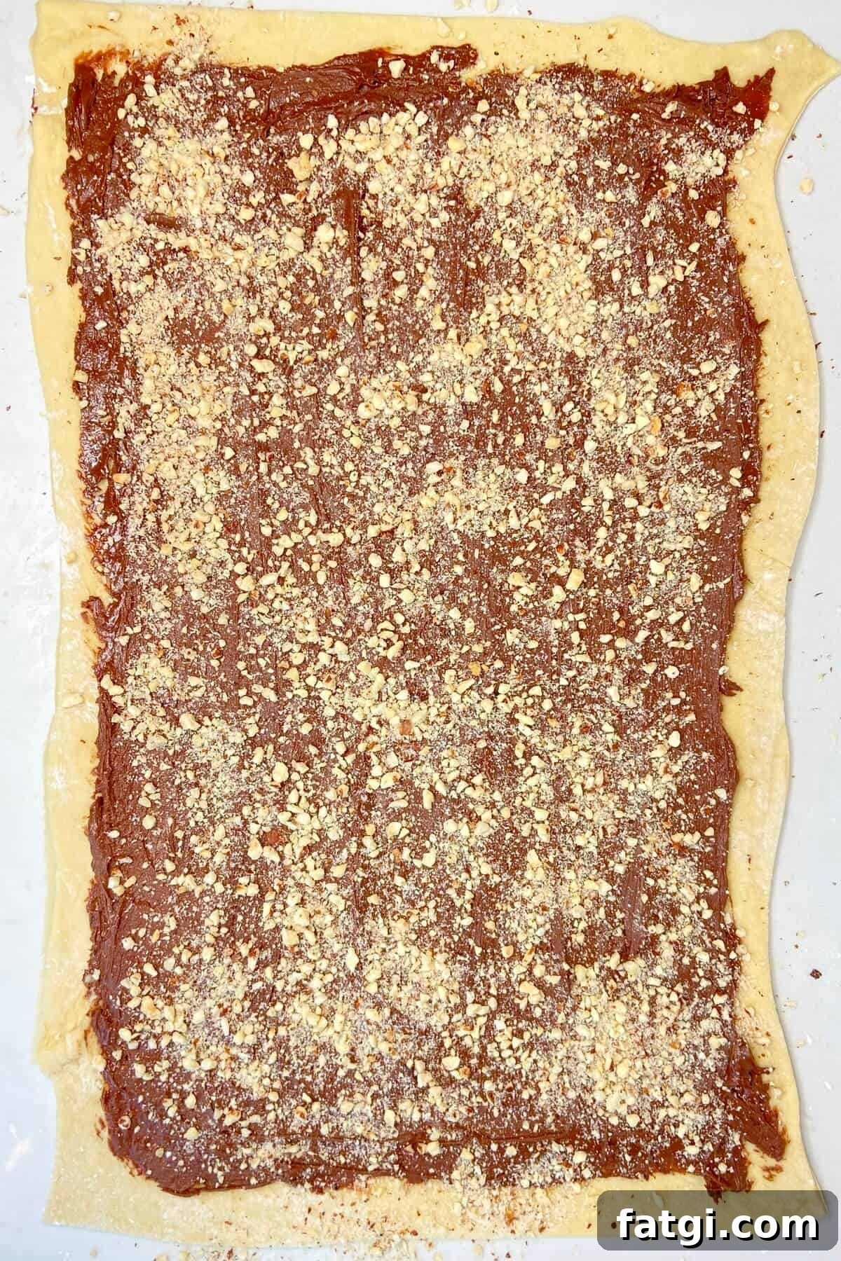 Spread filling and chopped nuts over rolled out dough.