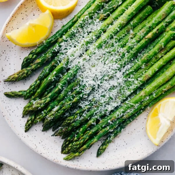 Easy roasted asparagus with fresh parmesan cheese and lemon slices.