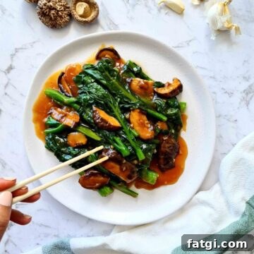 Plate of Chinese broccoli with mushrooms and sauce
