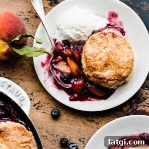 Plates of juicy blueberry peach cobbler.