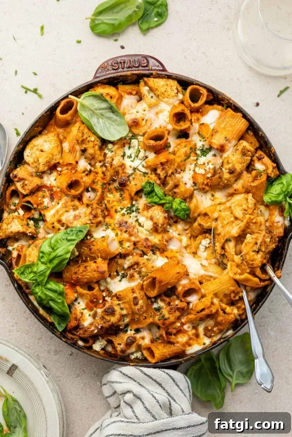 buffalo chicken pasta in a large skillet garnished with basil