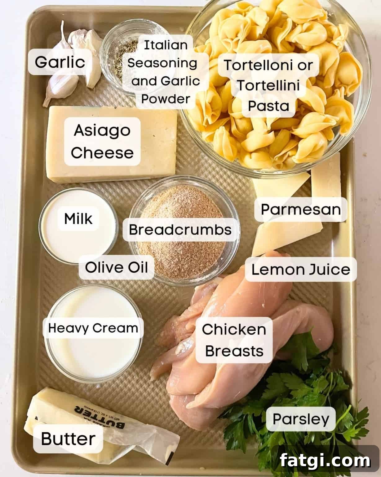 Asiago tortelloni alfredo with grilled chicken ingredients on a tray.