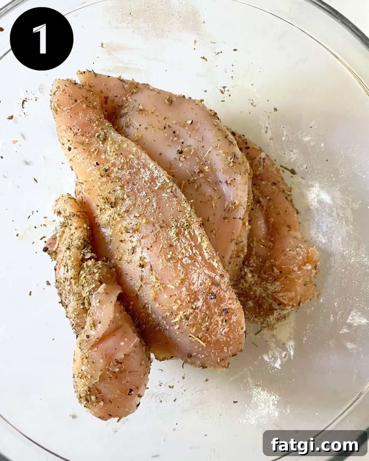seasoned chicken breasts in a bowl.