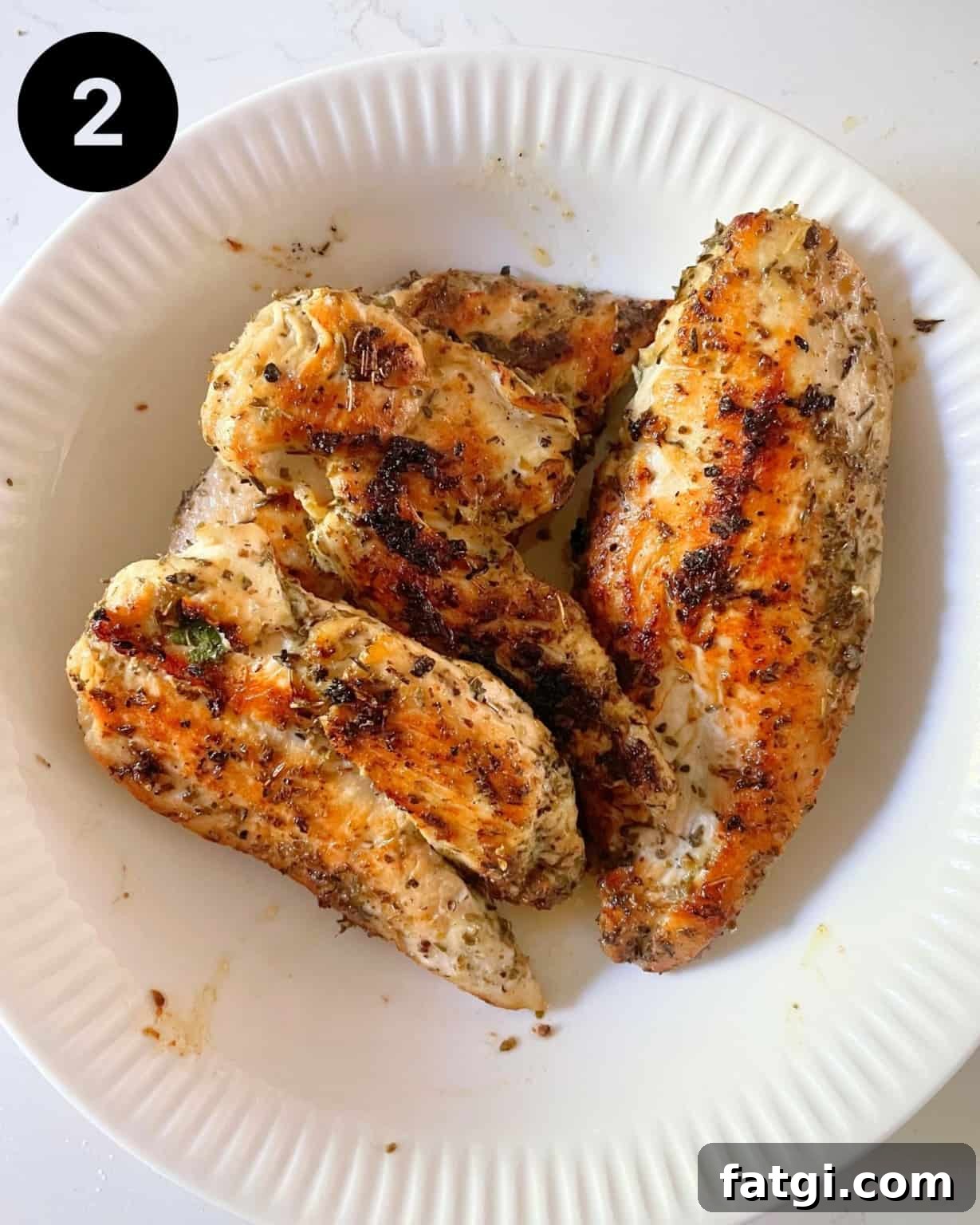 grilled chicken breasts in a bowl.