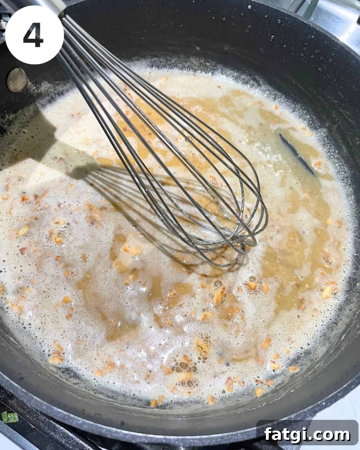 butter, minced garlic, and flour in a pan with a whisk.