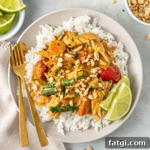 The served satay chicken over rice with fresh lime.