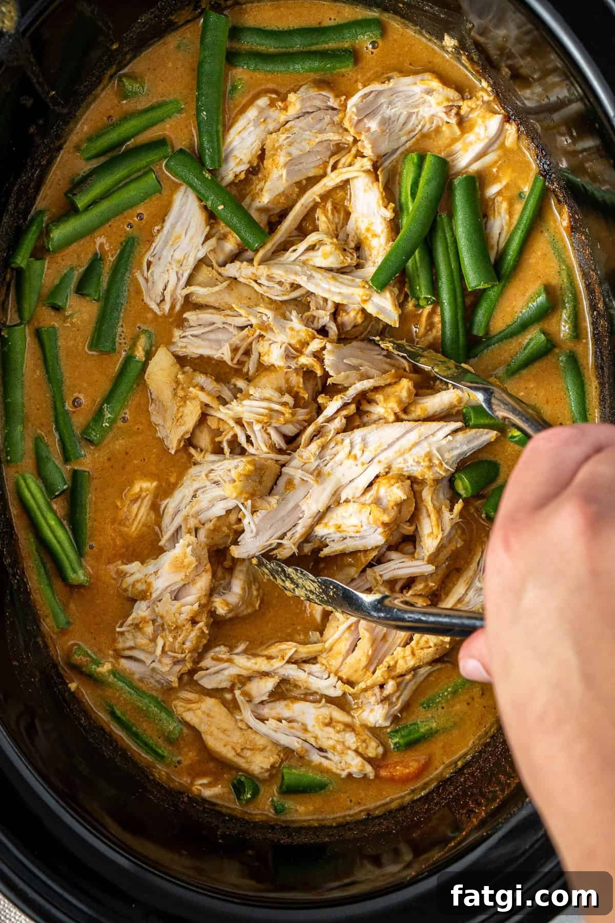 Shredding the chicken and adding the green beans.