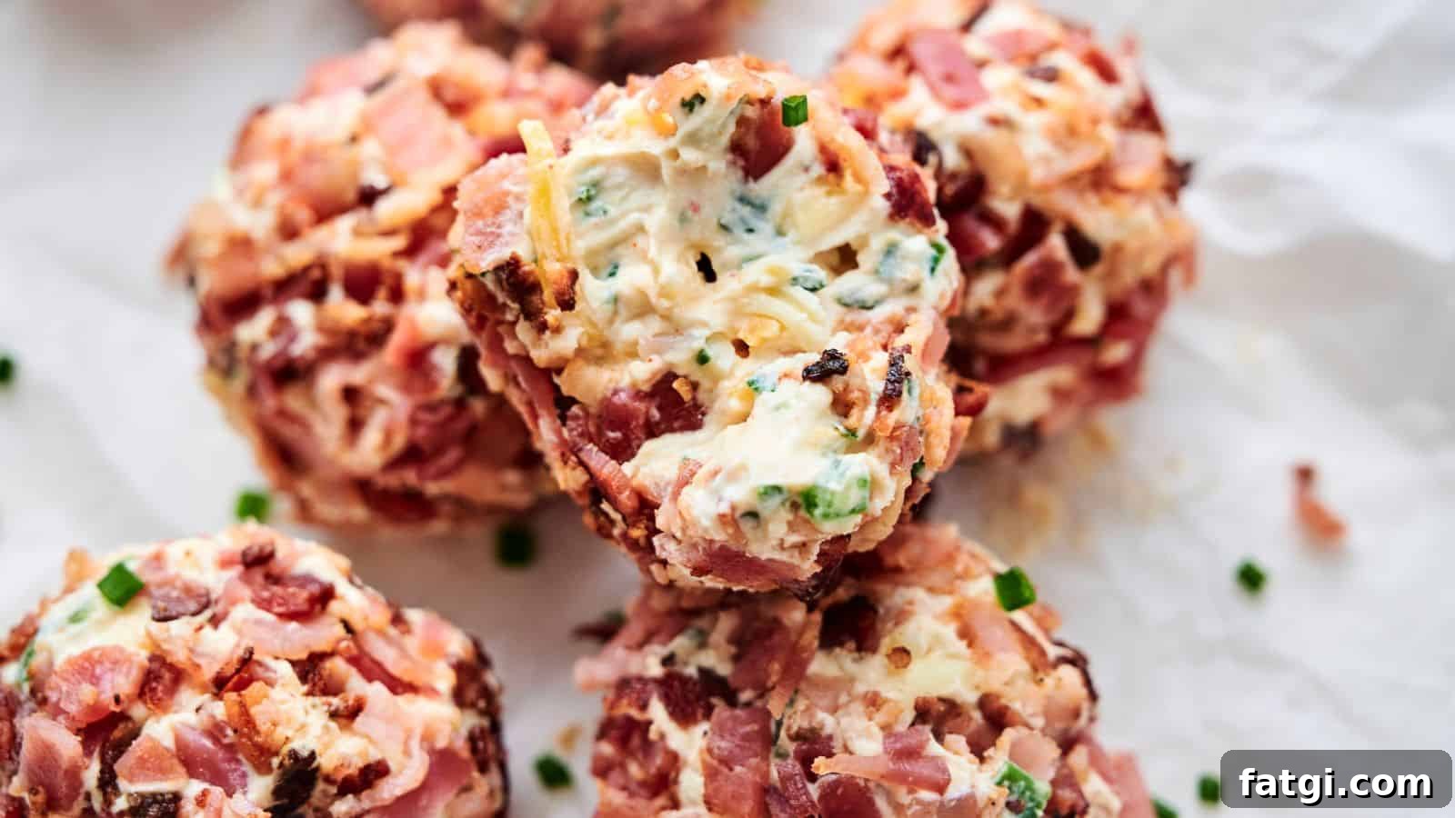 21 Pork Dinner Recipes for When You Need More on the Table 10 Close-up of several Bacon Jalapeno Popper Cheese Balls wrapped in bacon, stuffed with cheese, and seasoned with herbs and spices, placed on crumpled parchment paper.