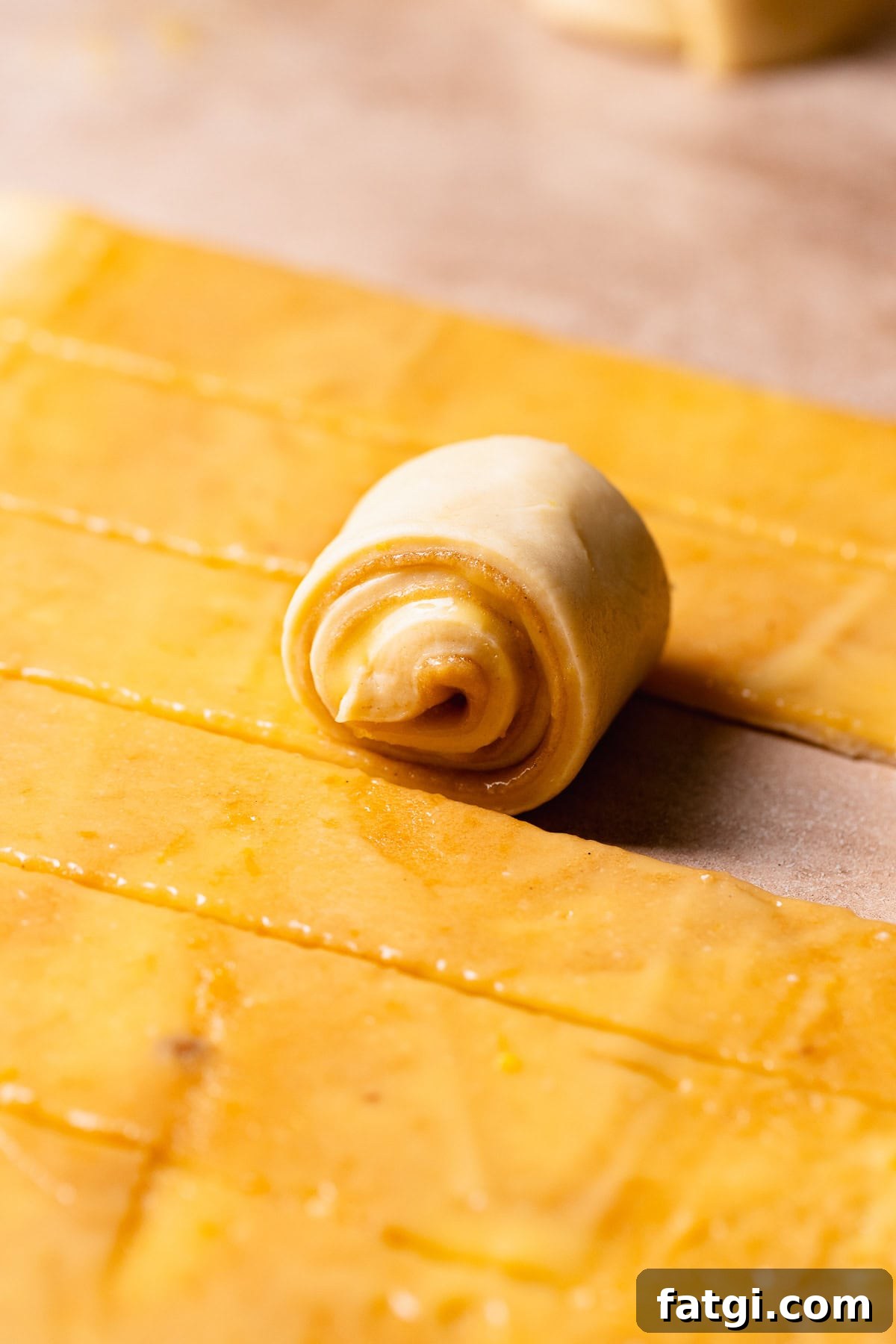 Lemon sweet rolls being rolled up.
