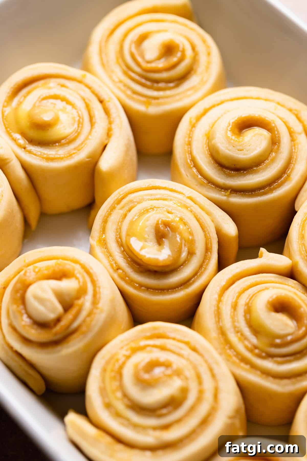 The sweet buns in a pan after they have doubled in size.