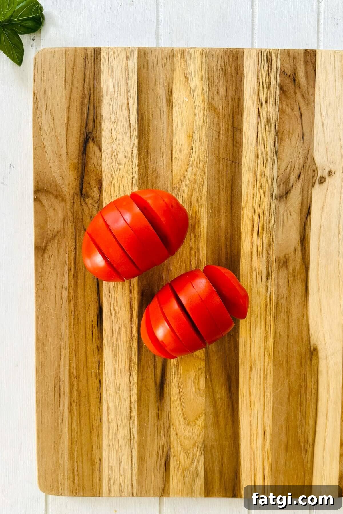 Stuffed Caprese Tomatoes with Mozzarella and Basil 4 a sliced tomato.