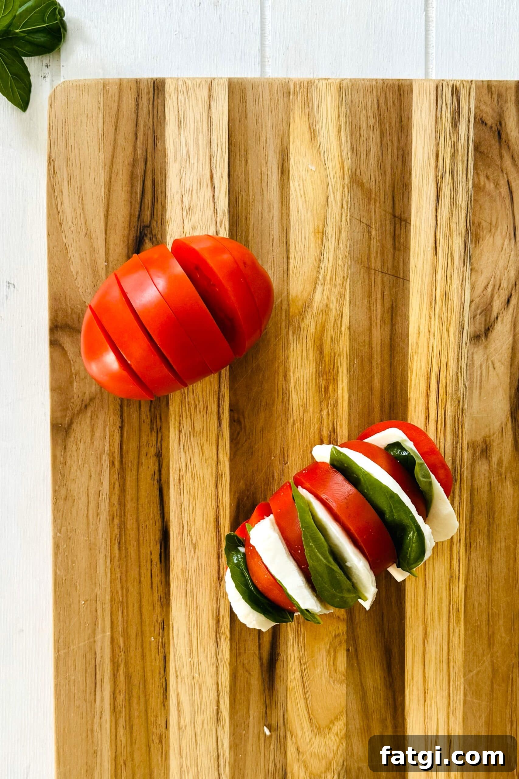 Stuffed Caprese Tomatoes with Mozzarella and Basil 5 sliced tomato and mozzarella stuffed tomato.