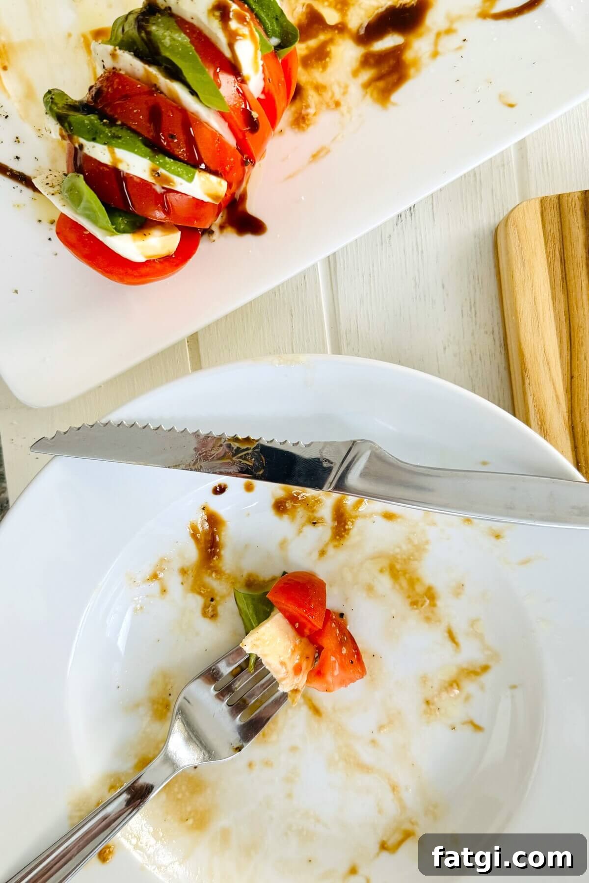 Stuffed Caprese Tomatoes with Mozzarella and Basil 8 a bite of caprese salad on a fork.