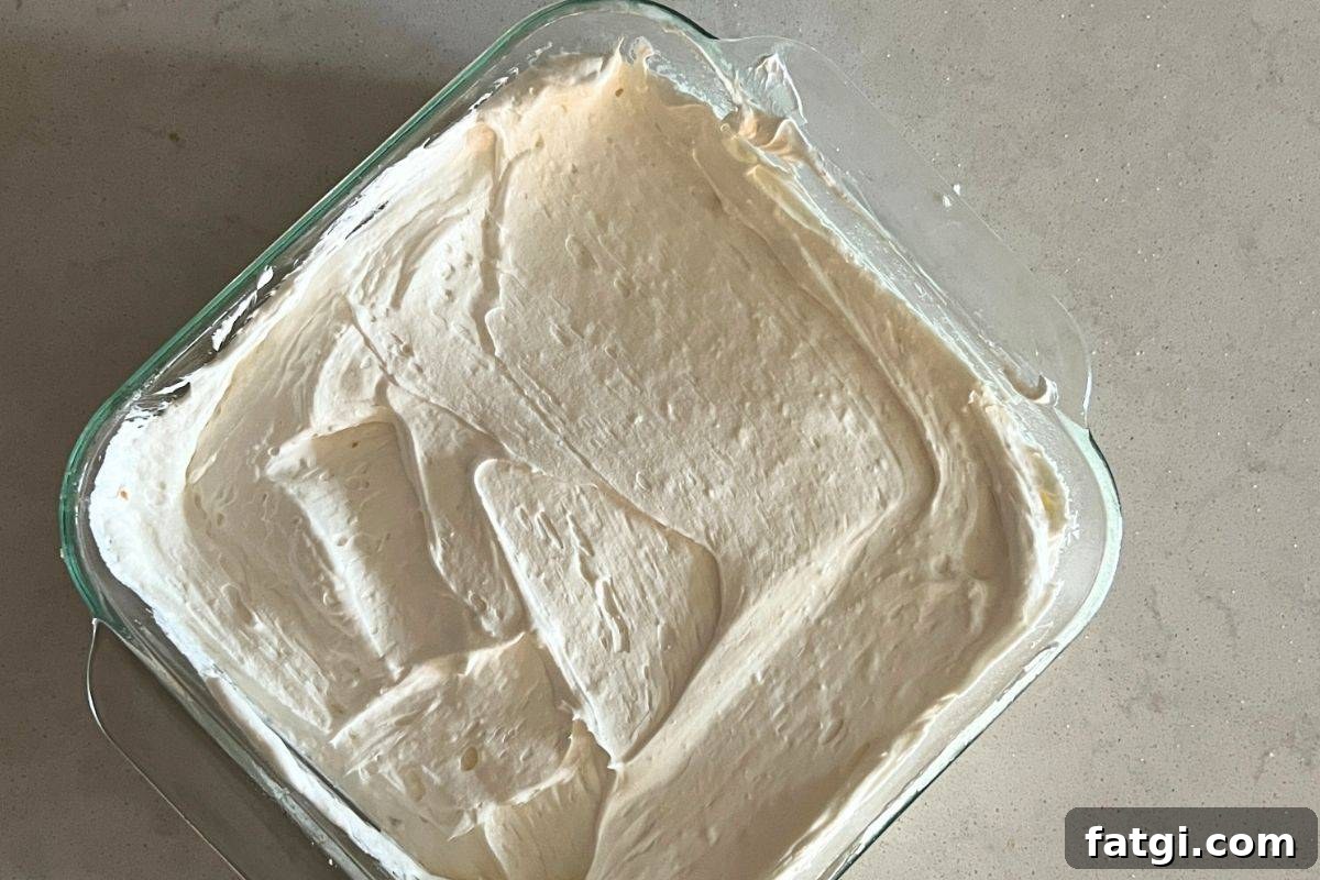 Cream cheese and whipped topping mixture spread over a cooled pretzel crust.