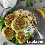 Cheesy Green Pea Fritters Recipe 13 Four pea fritters in a bowl with a portion of couscous and a dollop of Greek yoghurt.