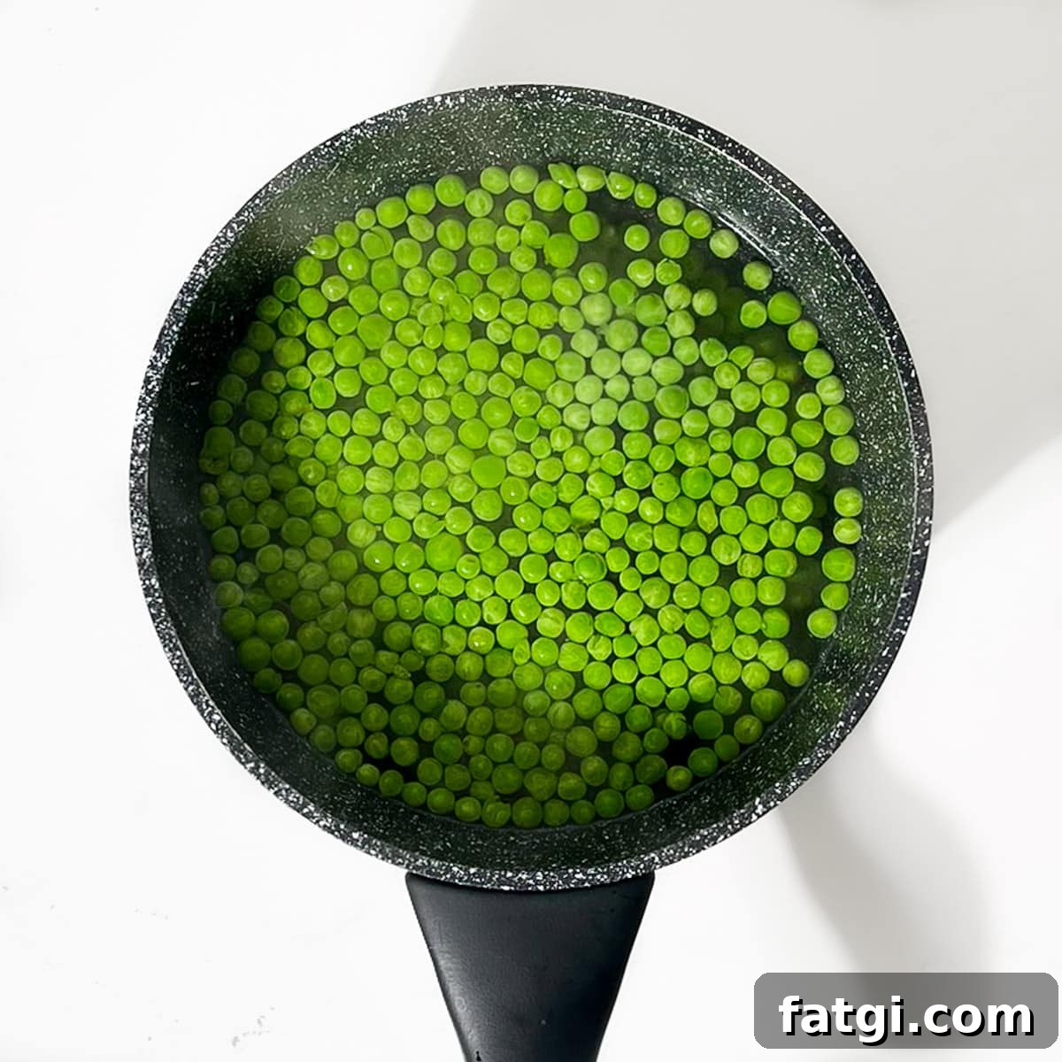 Cheesy Green Pea Fritters Recipe 4 Boiling the petit pois in a small saucepan.