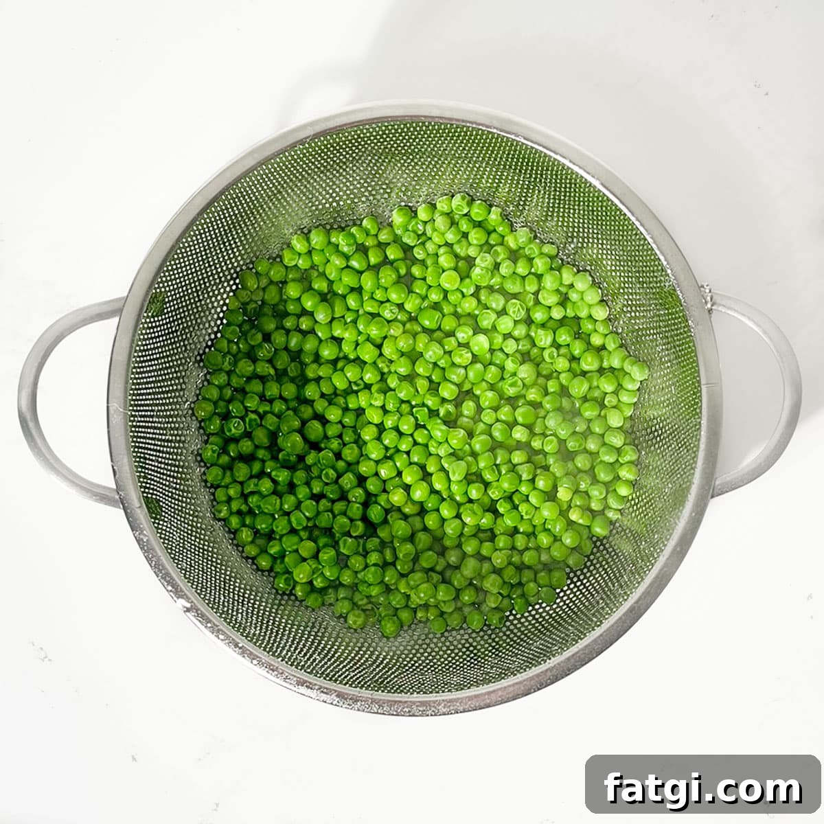 Cheesy Green Pea Fritters Recipe 5 Draining the cooked peas or petit pois in a colander.