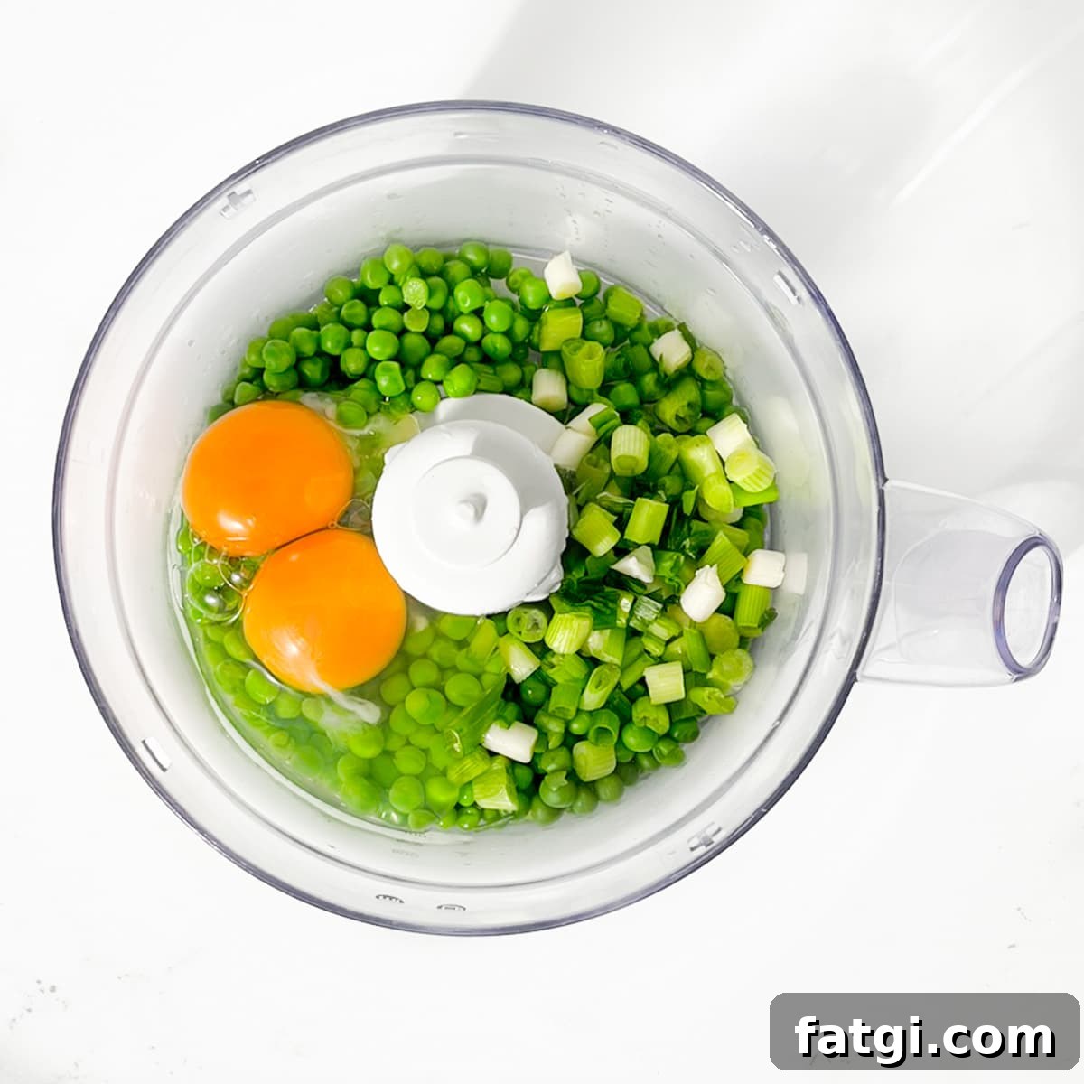 Cheesy Green Pea Fritters Recipe 6 Adding the peas, eggs and spring onions to a food processor.