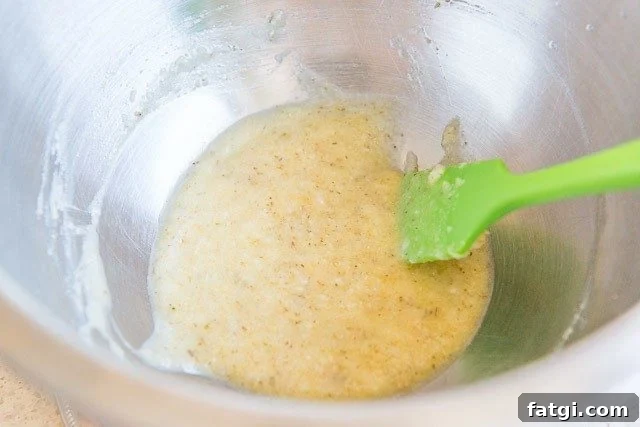 Crispy Garlic Parmesan Chicken Wings 6 Garlic Parmesan Sauce - In a Mixing Bowl with Green Spatula