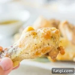 Close Up Of Garlic Parmesan Chicken Wing with Platter in Back