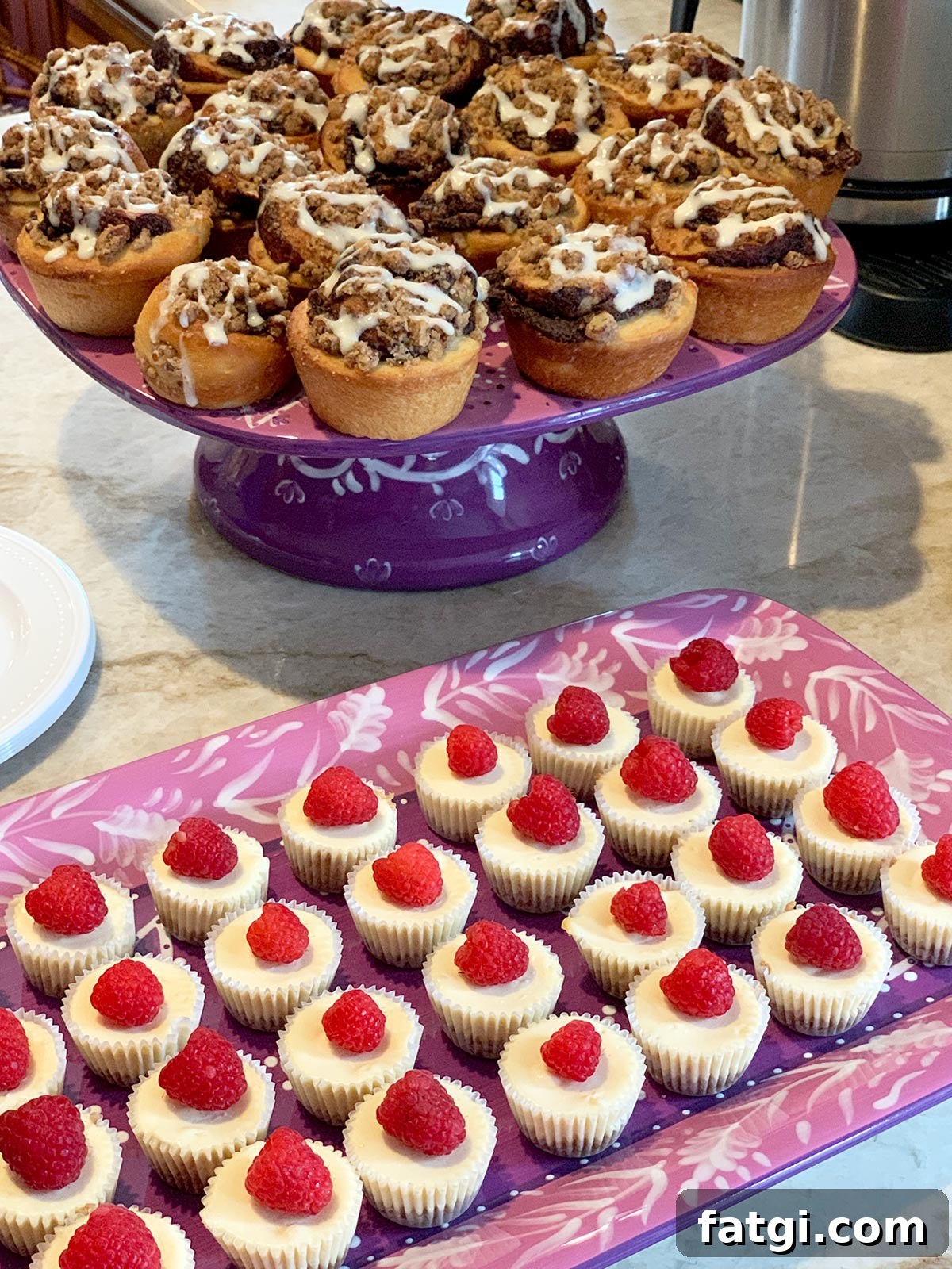 Mini cheesecakes on a purple platter with mini babkas in the background.