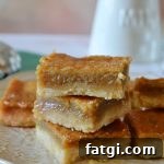 Sugar Pie Bars with Buttery Shortbread Crust 5 sugar pie squares stacked on a white plate and a green towel