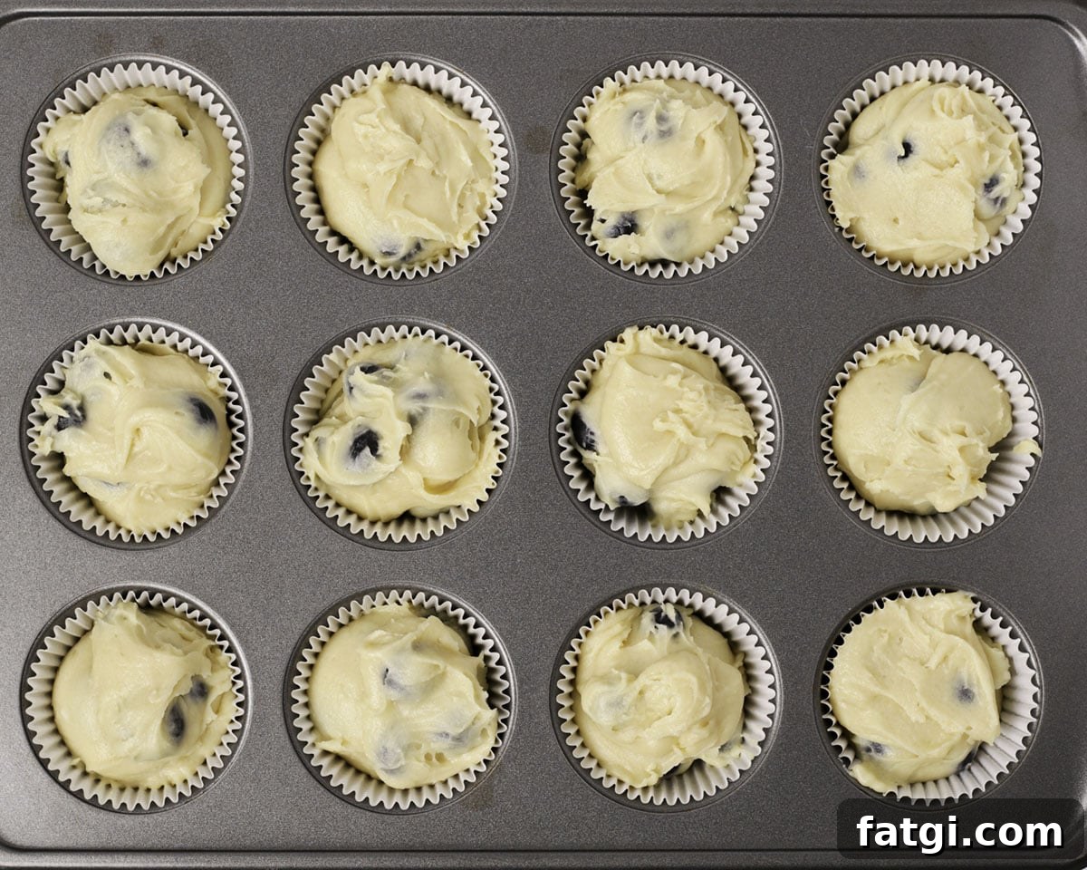 Blueberry muffin batter in muffin tin