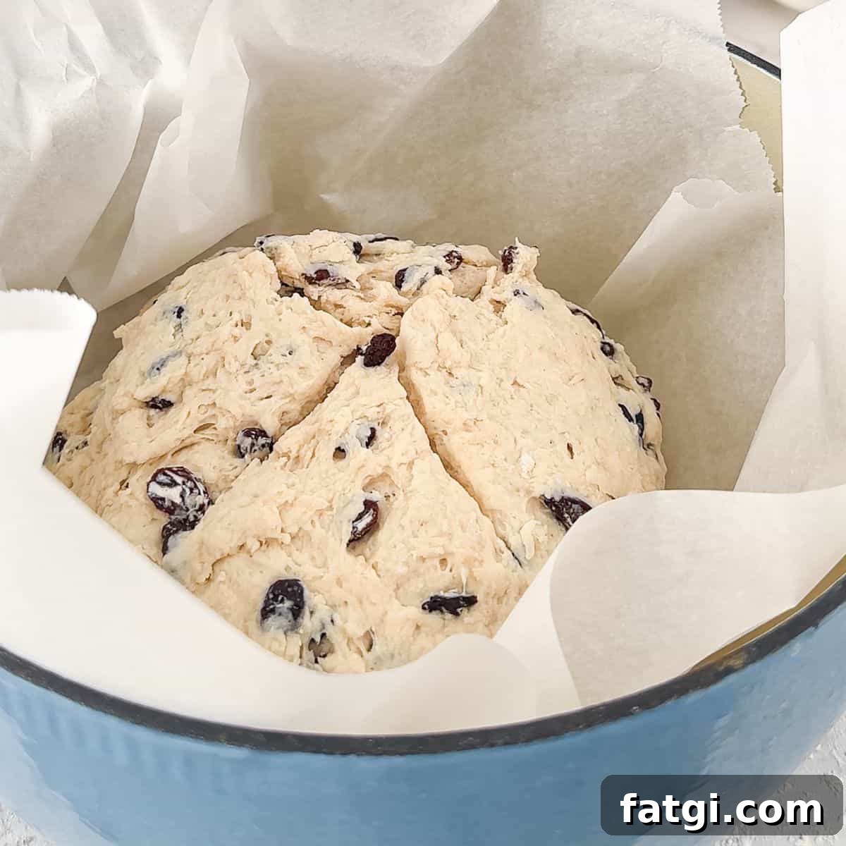 Adding the prepared dough to a dutch oven.