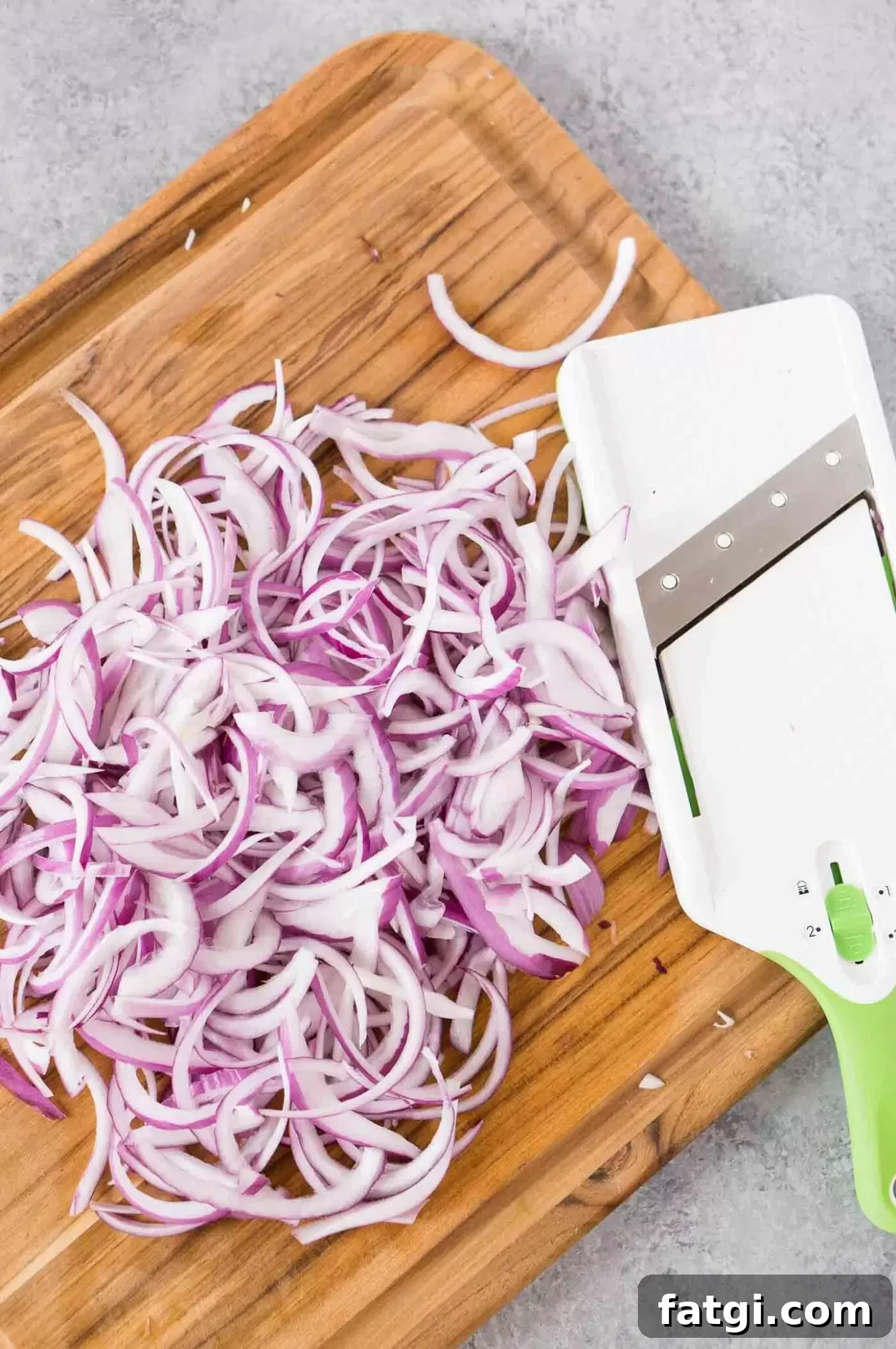 Pickled Red Onions Recipe for Tacos and Salads 4 thinly sliced red onion with mandolin on a cutting board