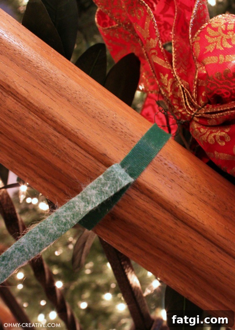 How to Hang Garland on a Staircase Banister 4 Attaching Christmas garland to a banister with a Velcro tie
