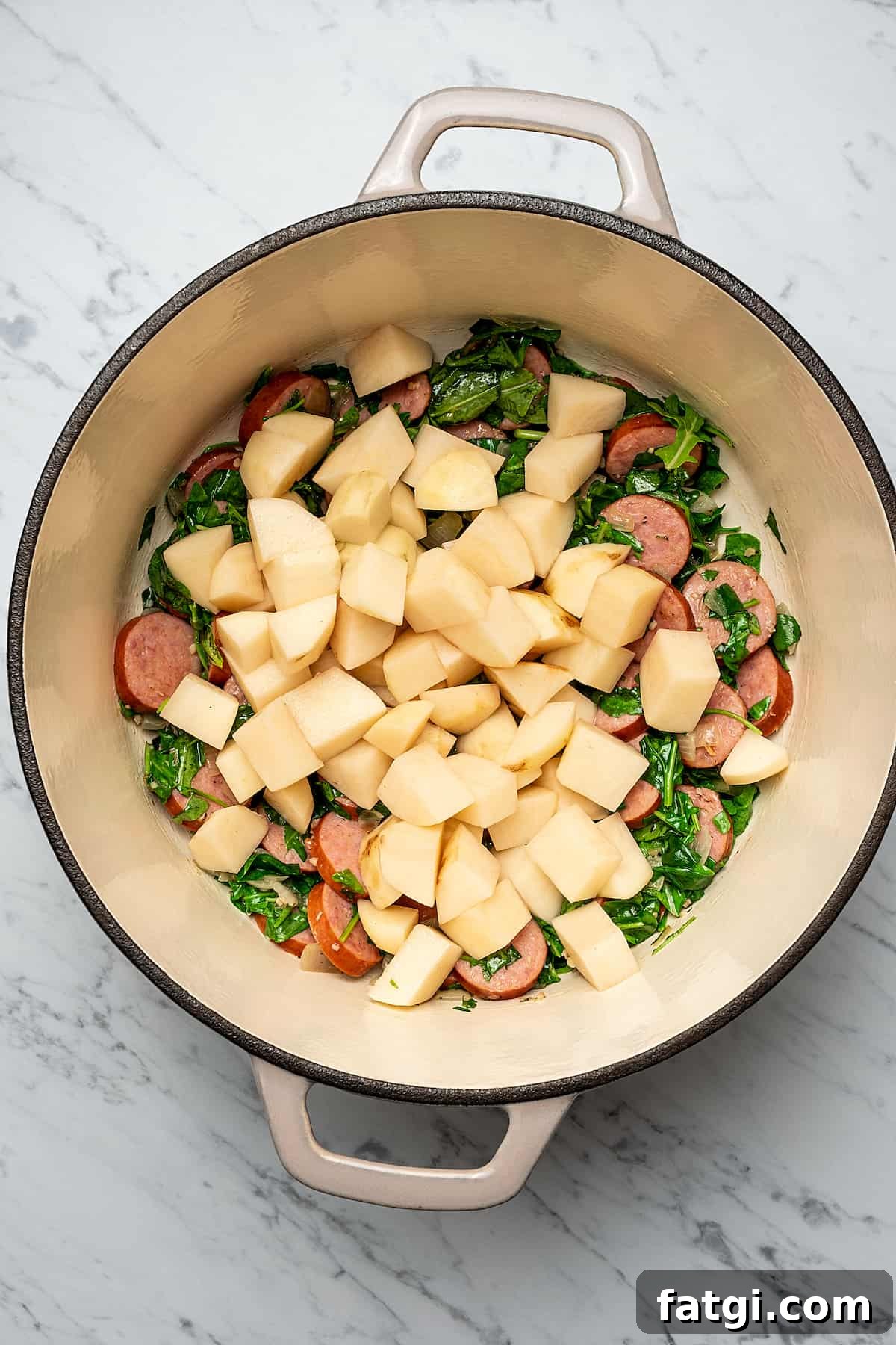 Potato soup ingredients in a pot.