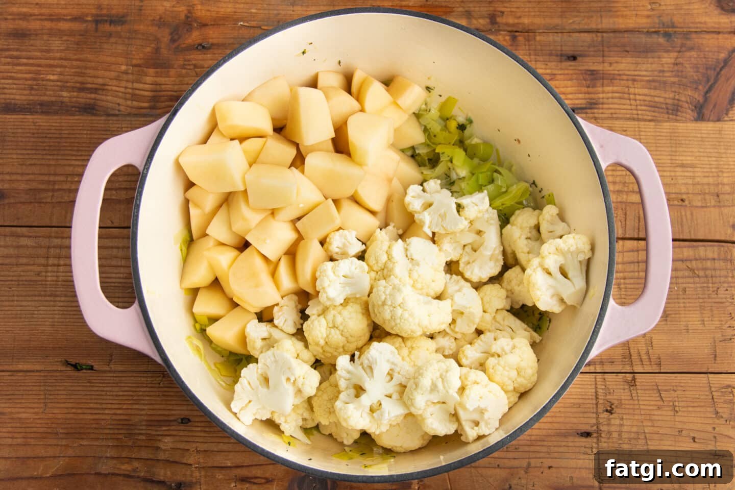 Creamy Cauliflower, Potato and Leek Soup Recipe 5 This is a picture of a big pot with leeks, cauliflower and potatoes added.