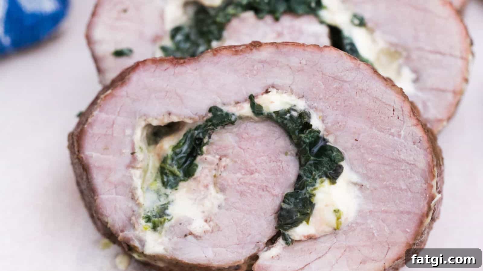 Stuffed steak pinwheels sliced on platter.