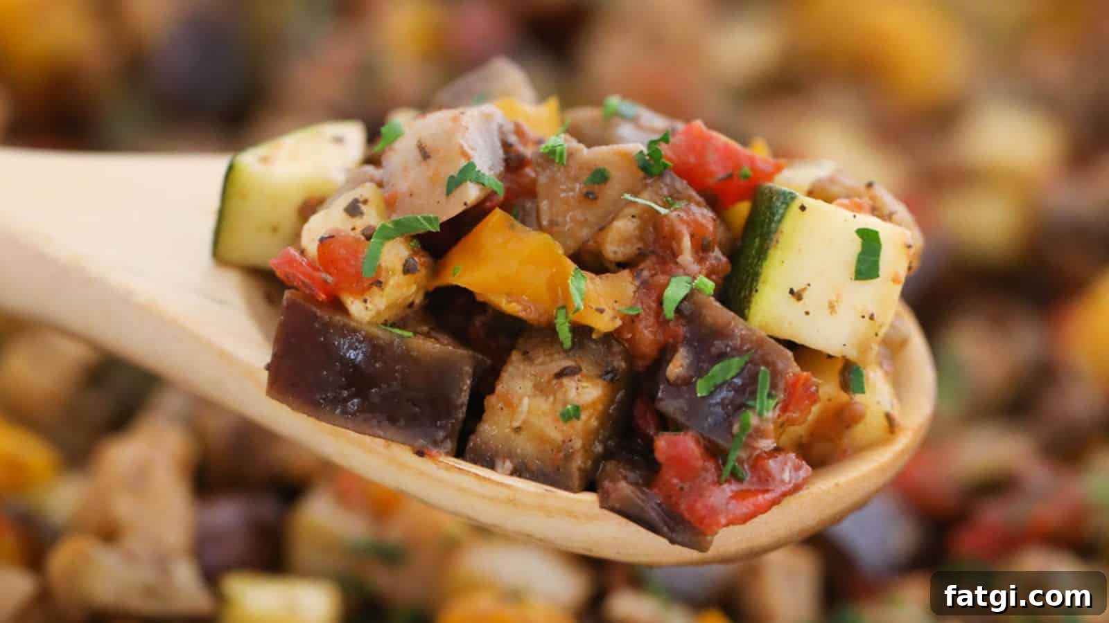 Close-up of a wooden spoon holding ratatouille, featuring chopped zucchini, bell peppers, and eggplant, garnished with parsley.