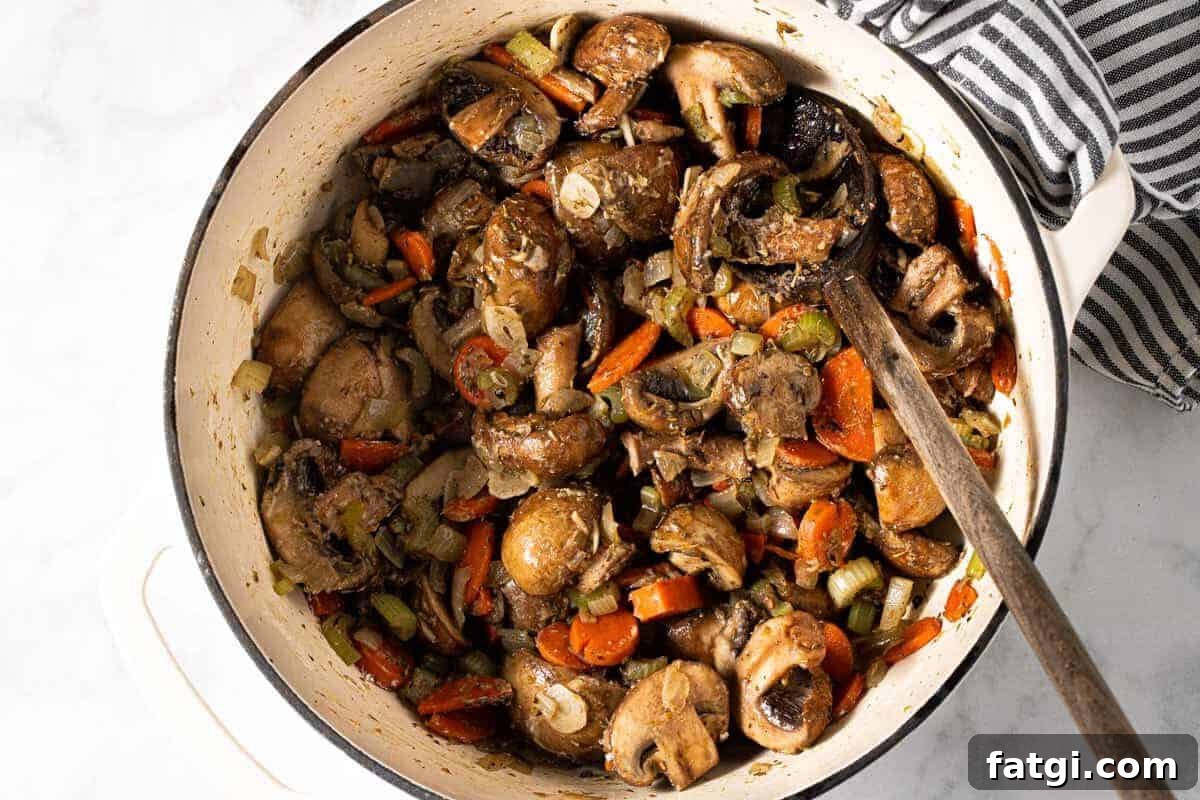Large white pot filled with ingredients to make a vegetable stew recipe